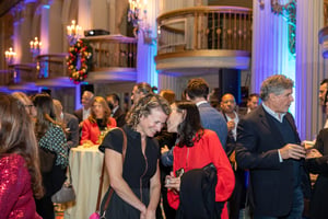 Guests gather and celebrate at the Central City Association’s holiday party, socializing in a festive indoor setting with warm lighting and seasonal décor.