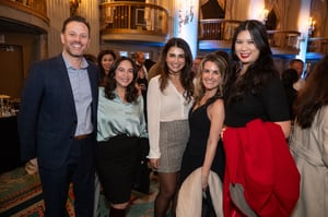 Guests gather and celebrate at the Central City Association’s holiday party, socializing in a festive indoor setting with warm lighting and seasonal décor.