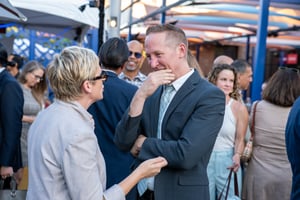 Guests converse and network at the Central City Association’s Elected Officials and Chiefs of Staff Reception at LA Plaza de Cultura y Artes in Downtown Los Angeles, engaging in conversation in a lively outdoor setting.