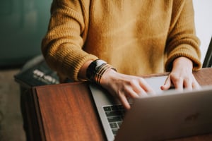 A person works on their laptop.